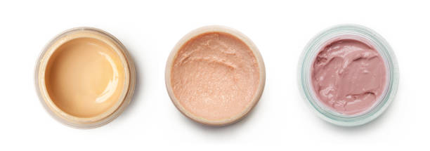 istock Different shades of liquid foundation in a containers isolated on white background, top view 1272150040