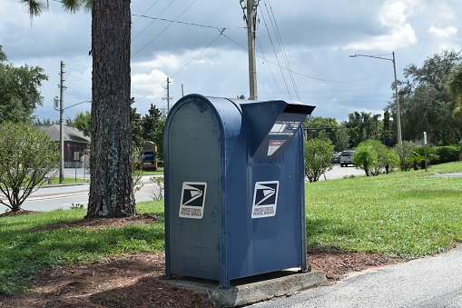 Front side of a large stand-alone official USPS blue mailbox on September 2, 2020 in a suburb of Orlando, Florida.
