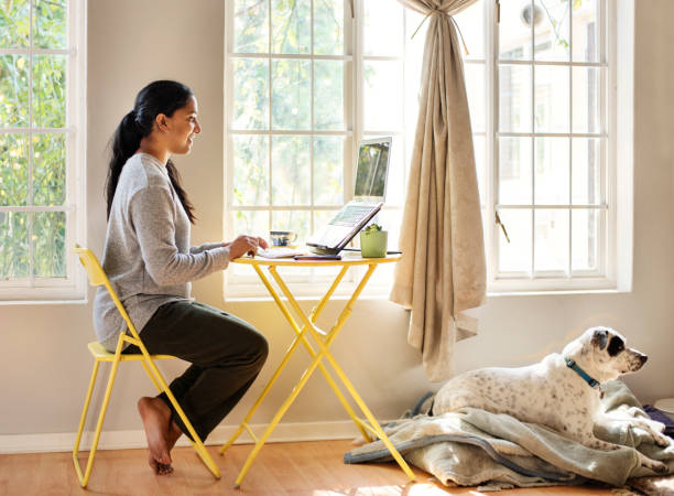 istock Young woman working remotely from home using a laptop 1272158199