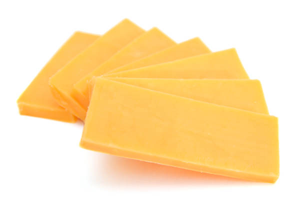 istock Cheddar cheese slices on white background. 1272160662