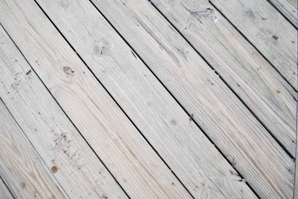 Close-up of worn weathered light brown wooden pier