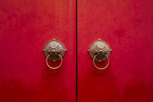 ancient red door with hand handle for background and retro backdrop