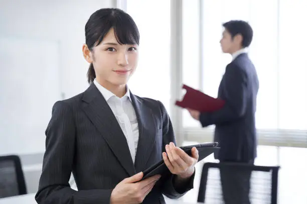 A smiling Japanese woman in her office