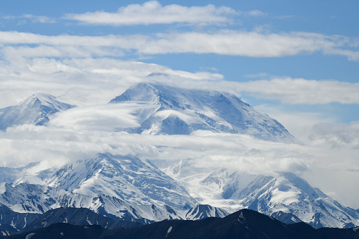 Mount Denali northwestern slopes seen from the area of Eielson, Denali National Park. This “wall”,  known as the Wickersham Wall, juts 14,000 ft upwards from the glacier to the North Peak of Denali. South Peak (the highest) hides in the  clouds to the left.