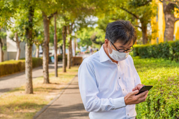 istock middle-aged man with mask working outdoor in Japan,summer 1272177323