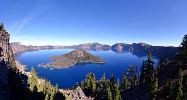 Panoramic view of a crater lake, deep blue water filling collapsed, volcanic caldera in Crater Lake National Park, Oregon, USA.