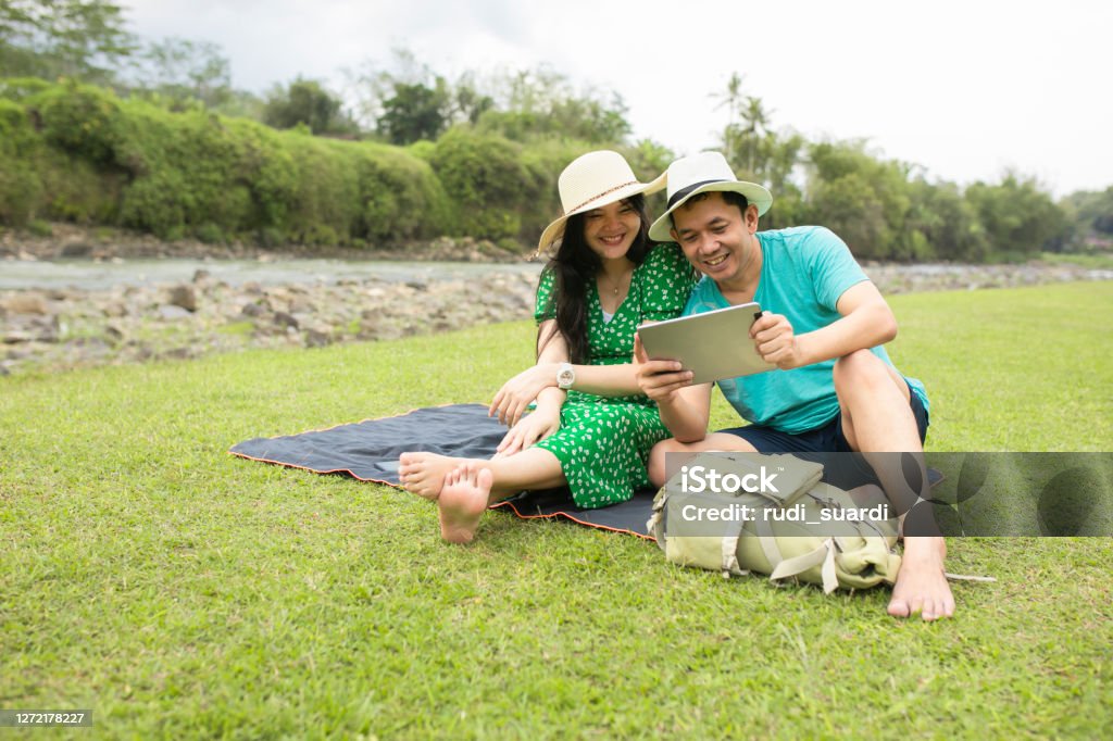 asian pregnant woman traveling on the rural when her husband working on-line Digital Tablet Stock Photo
