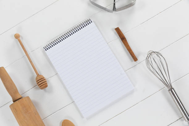istock View of a composition with a notebook with cookie cutters, whisker and rolling pin on a white wooden 1272181795