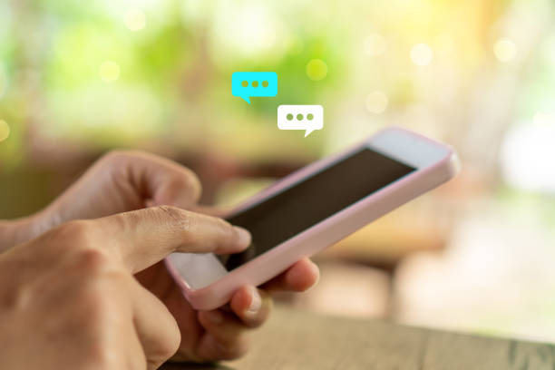 istock Women hand using smartphone typing, chatting conversation in chat box icons pop up. Social media maketing technology concept.Vintage soft color tone background. 1272184962