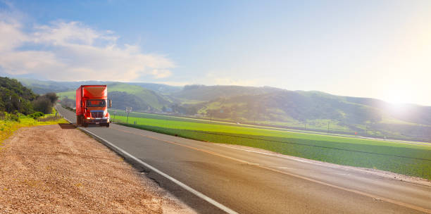 istock Red Truck on a country road 1272187943