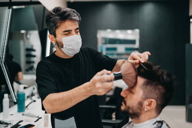 istock Barber cutting his customers hair during New Normal 1272194964
