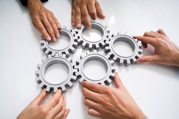 istock Innovative Businesspeople Team Hands Joining Gears 1272197489