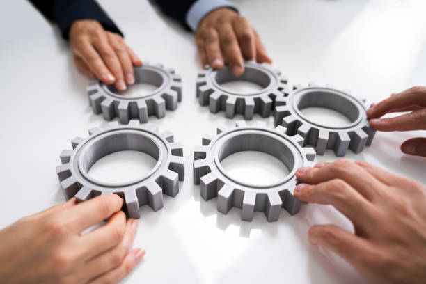 istock Innovative Businesspeople Team Hands Joining Gears 1272197490