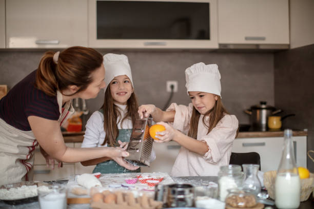 istock Mother and girls making Cake 1272198531