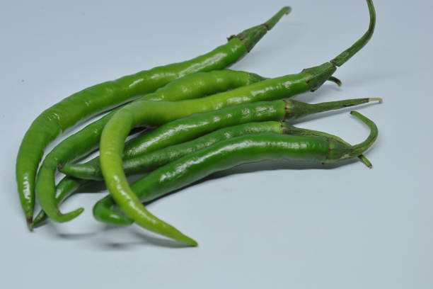 istock Green cayenne pepper with a white background 1272198795