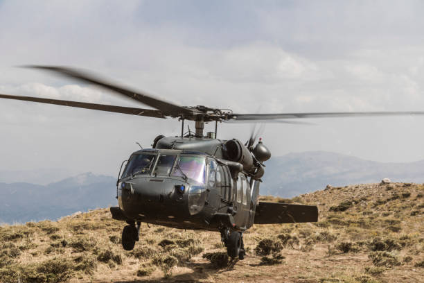istock UH-60 Black Hawk Military Helicopter landing on battlefield 1272203087