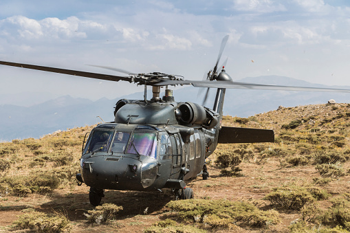 Apache in combat. Helicopter battle training, low flight in natural airfield on Suur-Pakri island, Estonia, Europe.