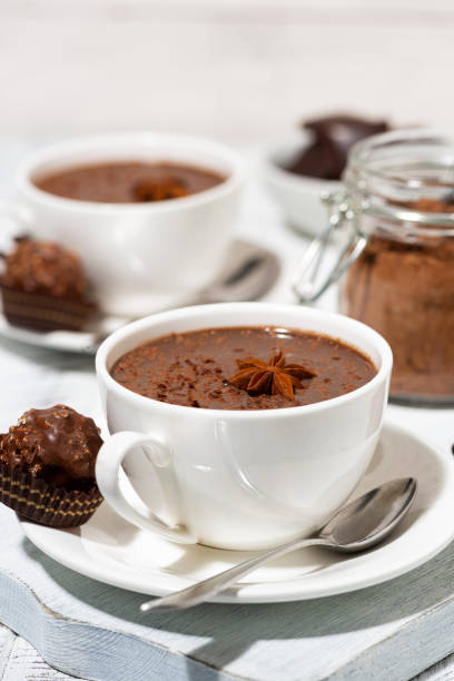 istock hot chocolate and sweets on white table, vertical closeup 1272204212