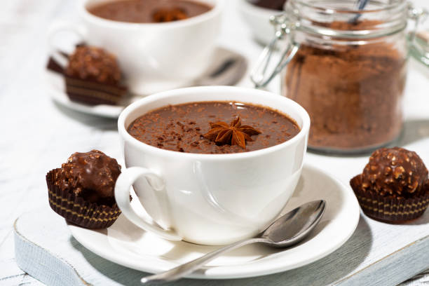 istock hot chocolate and sweets on white table, closeup 1272204229