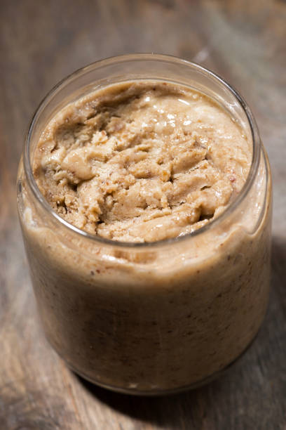 istock homemade peanut butter in a jar, vertical 1272204235