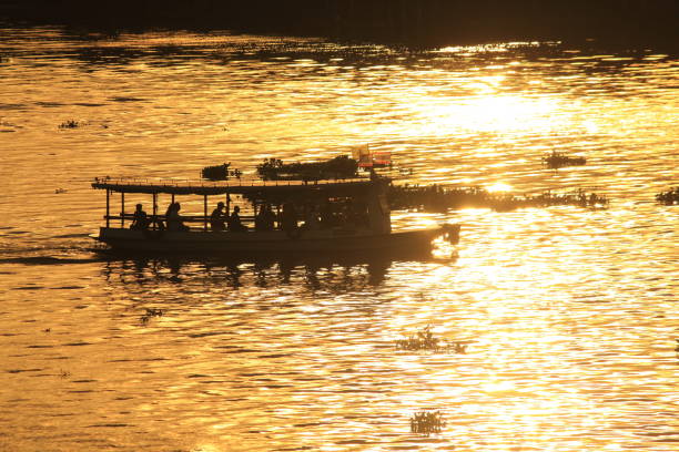 Sunset in and the boat in the river