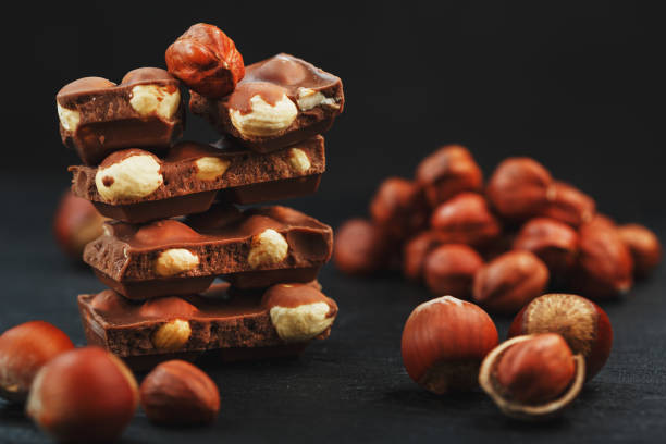 istock Chocolate with hazelnut on a black background close-up. 1272207238