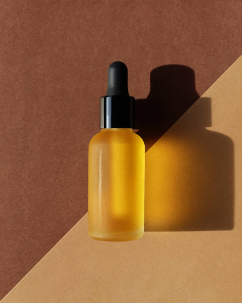 istock Vertical mockup of dropper oil bottle, double diagonal background 1272207610