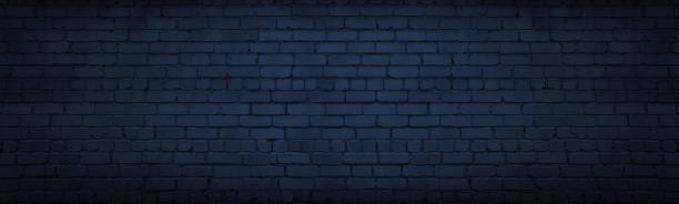 Navy blue brick wall wide texture. Dark indigo masonry large long background. Gloomy night backdrop