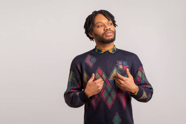 istock Self confident egoistic guy with dreadlocks pointing hands on himself with arrogant face, proud of start up 1272208799