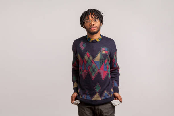 istock Depressed jobless african man with dreadlocks in eyeglasses demonstrating empty pockets sadly looking at camera, bankruptcy, crisis 1272208804