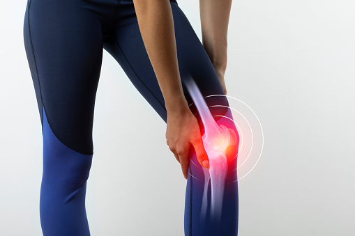 Sport woman suffering from pain in knee
