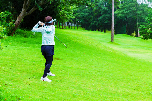 istock woman playing golf in japan 1272219656