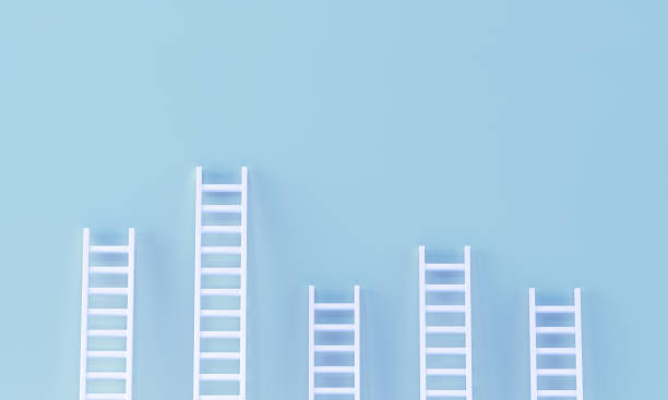 istock Ladder random collection on pastel blue wall. minimal studio background. 1272219750