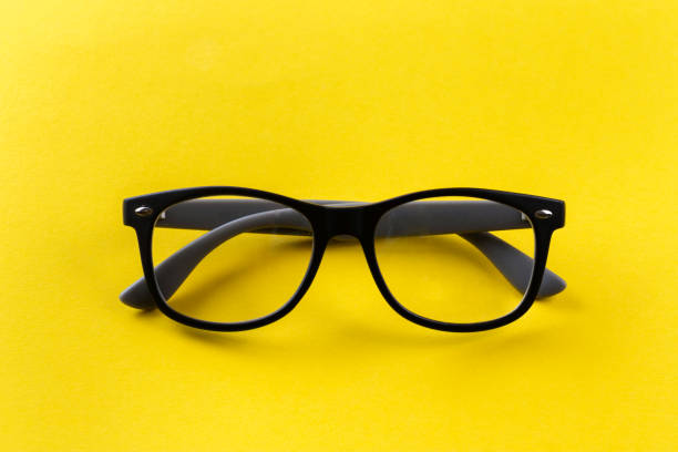 istock Glasses for vision in black frames on a yellow background. 1272223545