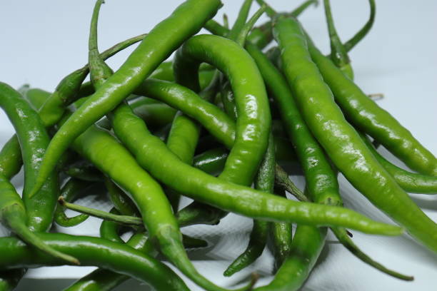 istock Green cayenne pepper with a white background 1272227571