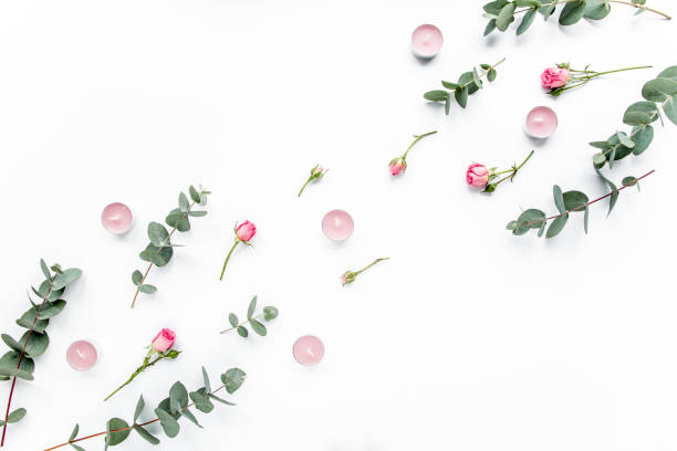 istock Floral pattern made of pink roses, green leaves eucalyptus, branches on white background. Flat lay, top view. Valentine's background. Floral pattern 1272229357