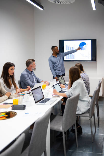 istock Businessman giving presentation with colleagues 1272229692