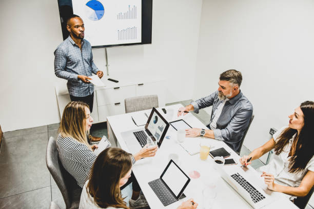 istock Businessman giving presentation with colleagues 1272229710