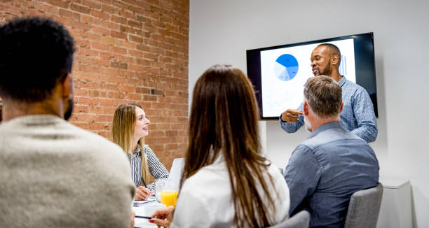istock Businessman giving presentation with colleagues 1272230516