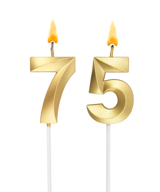 istock Golden birthday candles isolated on white, number 75 1272230801