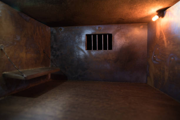 istock Jail or prison cell. Old grunge prison miniature. Dark prison interior creative decoration. Empty cell. Selective focus Obsolete gray grunge concrete room. 1272231454