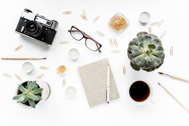 istock desk workspace with succulent, coffee, diary, glasses and golden clips on white background. flat lay, top view 1272231738