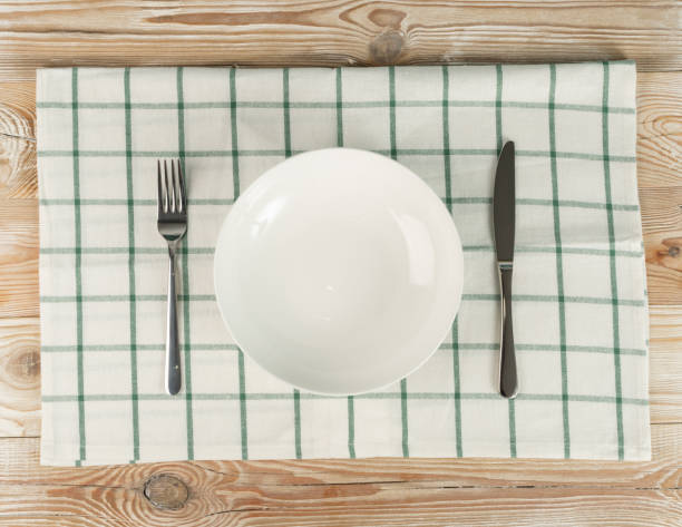 istock Empty Plate on White Wooden Table Top View with Copy Space 1272233163