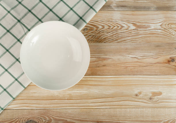 istock Empty Plate on White Wooden Table Top View with Copy Space 1272233176