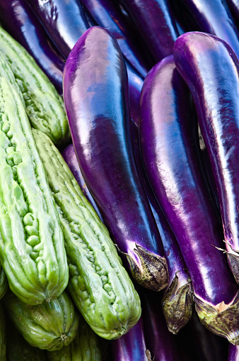 Vegetables: Eggplant and Zucchinis in street market. Purple color