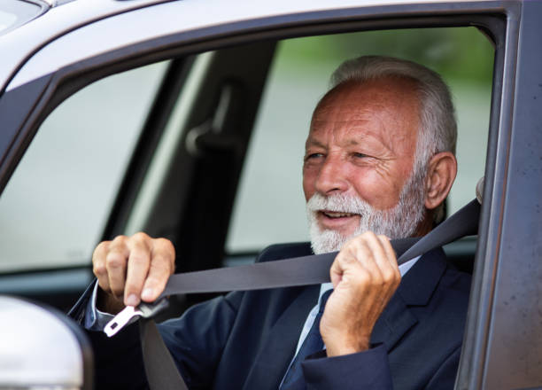 istock Senior man tying seatbelt in car 1272240302