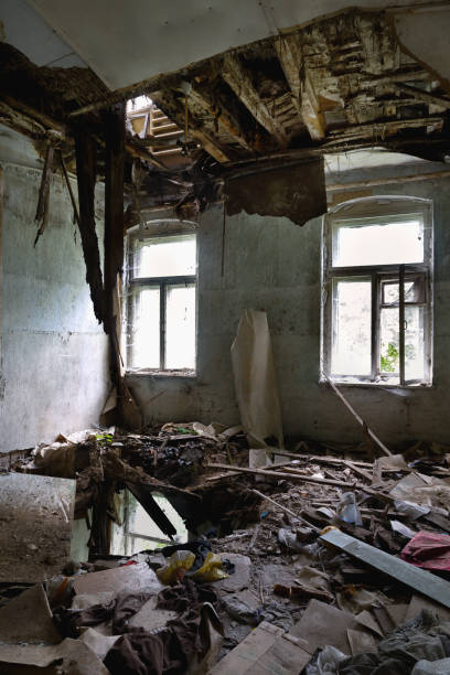 istock Interior of a living room with a collapsed ceiling and floor 1272245892