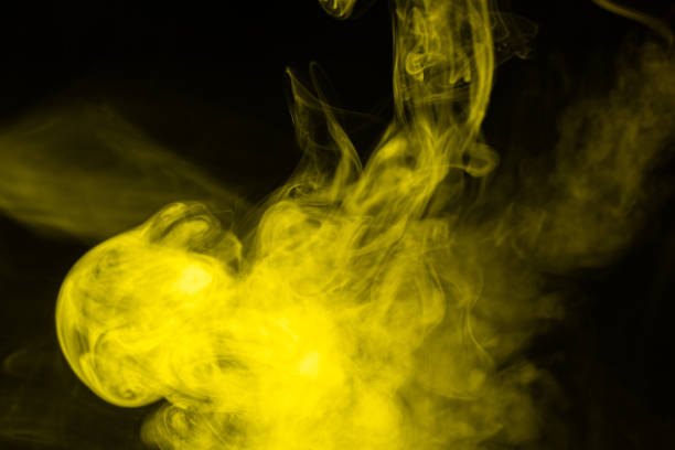 istock Yellow steam on a black background. 1272247398