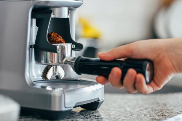 Coffee beans in a portafilter by the coffee grinder