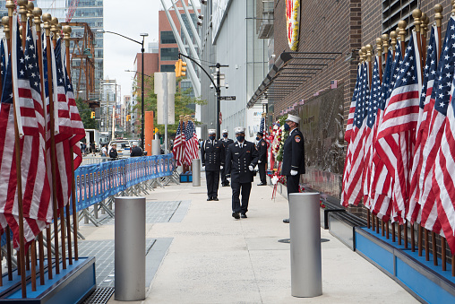 Manhattan, New York. September 11, 2020. FDNY firefighters wearing masks perform the changing of the guard at the FDNY Memorial Wall near the World Trade Center in Lower Manhattan on the 19th anniversary of the attacks.